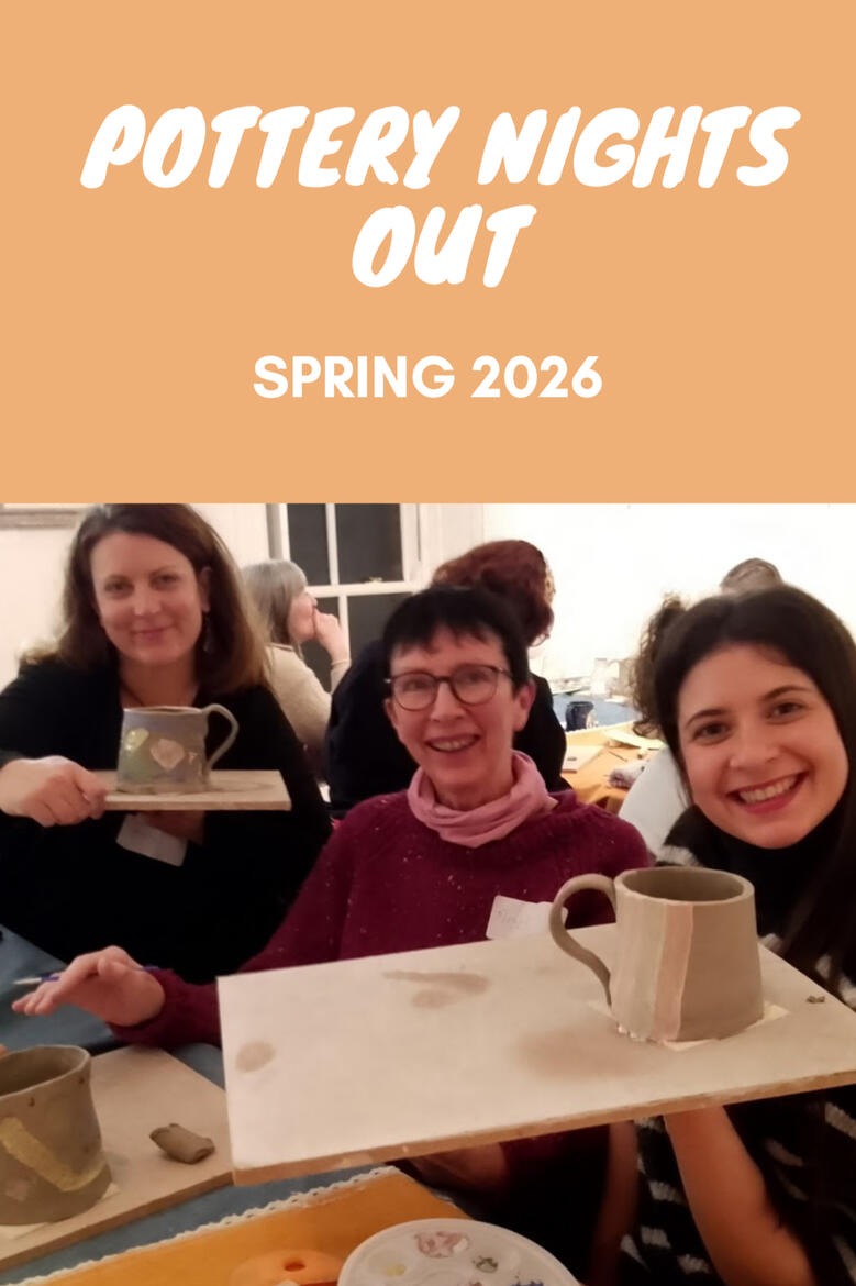 three women smile and show their handmade mugs during a pottery workshop event
