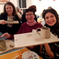 Painting Pottery Close up of a child's hand while painting a ceramic imprint of their own hand