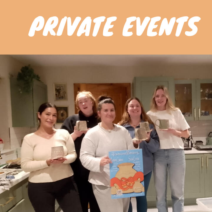 five women smiling and showing their unfired clay mugs made during a private pottery event