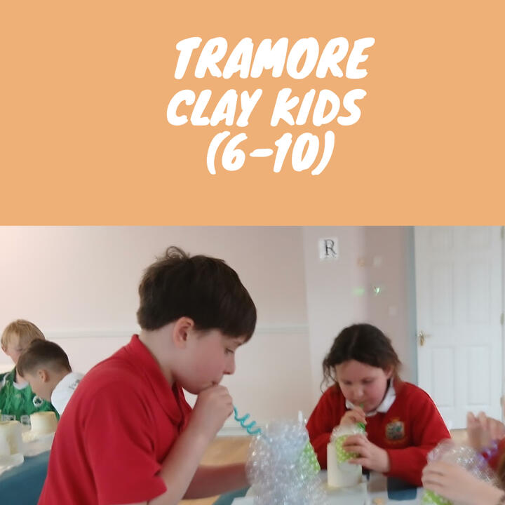 Children blowing glaze onto bisque ceramics