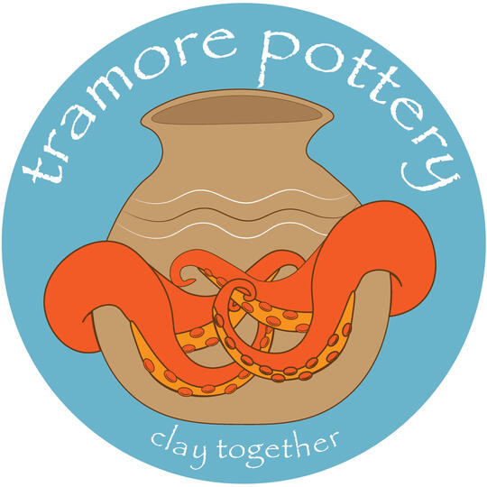 a picture of a clay case embraced by orange octopus tentacles with the words TRAMORE POTTERY - clay together
